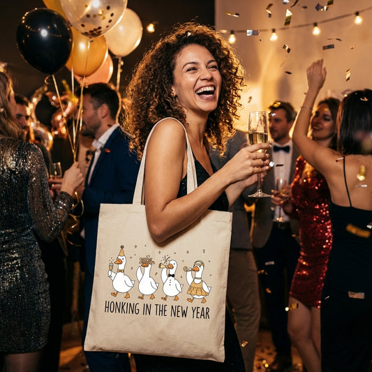 Honking in the New Year DTF transfer design mockup on a canvas tote bag featuring four cartoon geese in party attire celebrating the New Year