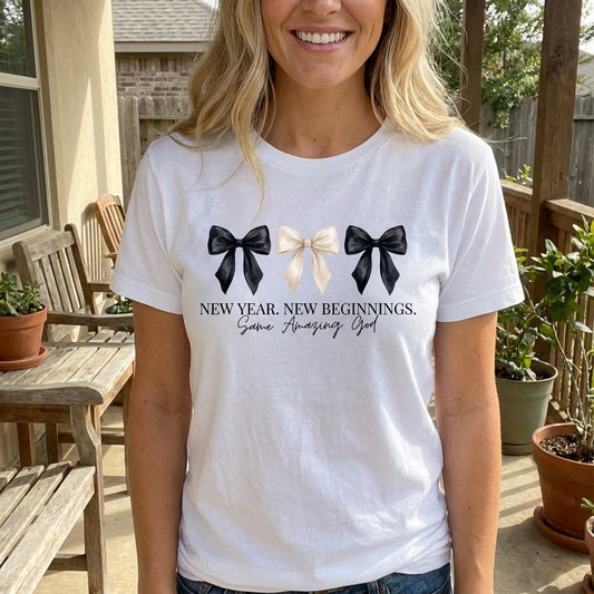 New Year New Beginnings Same Amazing God Coquette DTF transfer design mockup on a white t-shirt featuring three watercolor bows in black and ivory with the script New Year New Beginnings Same Amazing God