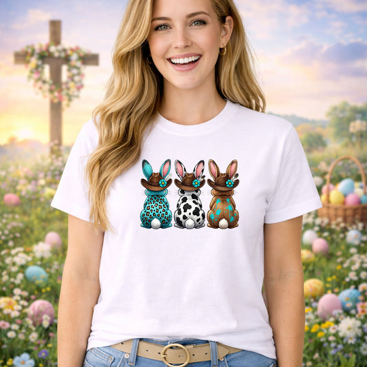 Three Western Bunnies DTF transfer design mockup on a t-shirt featuring three western bunnies in cowboy hats with leopard, cow print and floral patterned bodies