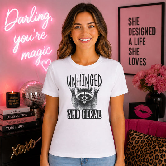 Unhinged And Feral Raccoon DTF transfer mockup on a t-shirt featuring a cartoon raccoon throwing rock and roll hand signs with sassy text