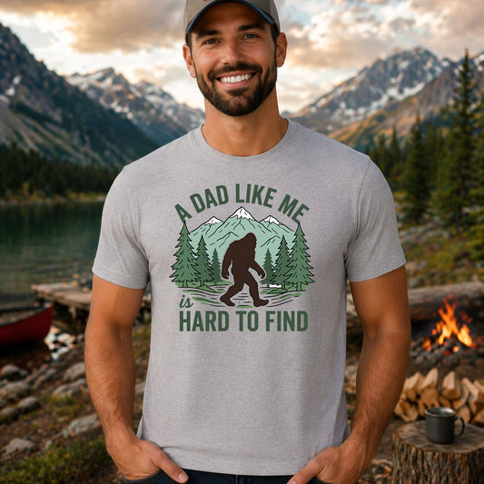 A Dad Like Me Is Hard To Find DTF transfer design mockup on a t-shirt featuring a Bigfoot silhouette in pine forest with A Dad Like Me Is Hard To Find typography