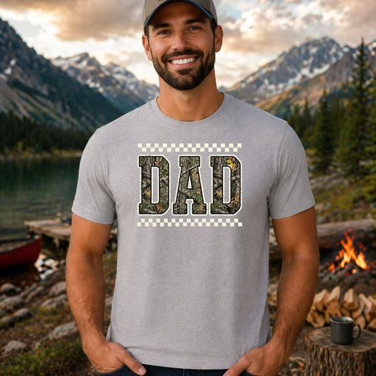 Dad Camo DTF transfer design mockup on a t-shirt featuring bold DAD lettering filled with realistic forest camouflage pattern