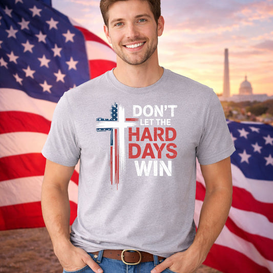 Don't Let The Hard Days Win DTF transfer design mockup on a t-shirt featuring a patriotic painted cross with Don't Let The Hard Days Win typography