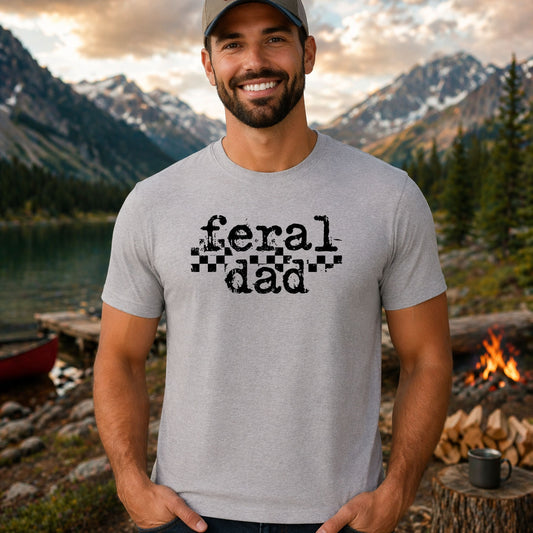 Feral Dad DTF transfer design mockup on a t-shirt featuring bold black FERAL DAD lettering with checkered racing flag accent
