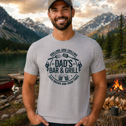 Grilling And Chilling DTF transfer design mockup on a t-shirt featuring a circular Dad's Bar and Grill emblem with grilling tools and Cold Brews and Good Times tagline
