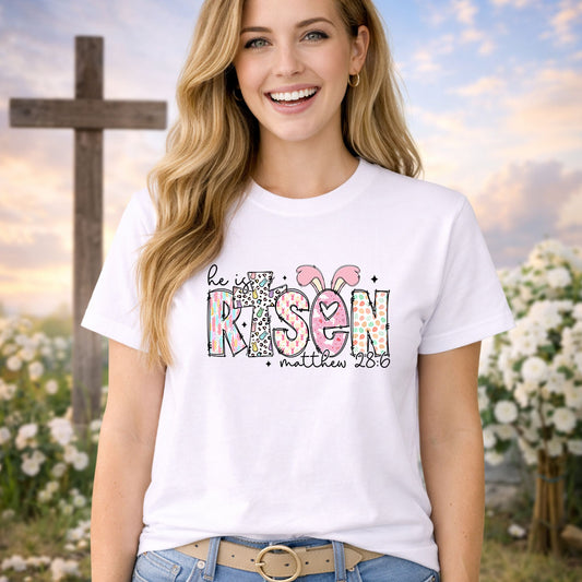 He Is Risen Easter Print DTF transfer design mockup on a t-shirt featuring He Is Risen typography styled as RIS3N with Matthew 28:6 reference in pastel patterns