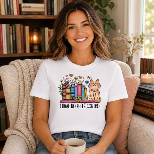 I Have No Shelf Control DTF transfer mockup on a t-shirt featuring books, flowers, and an orange tabby cat in glasses on a shelf