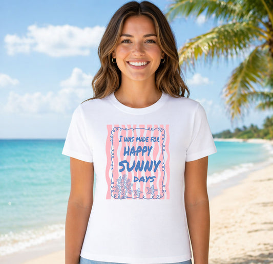I Was Made For Happy Sunny Days DTF transfer mockup on a t-shirt featuring blue text on pink waves with coral and starfish
