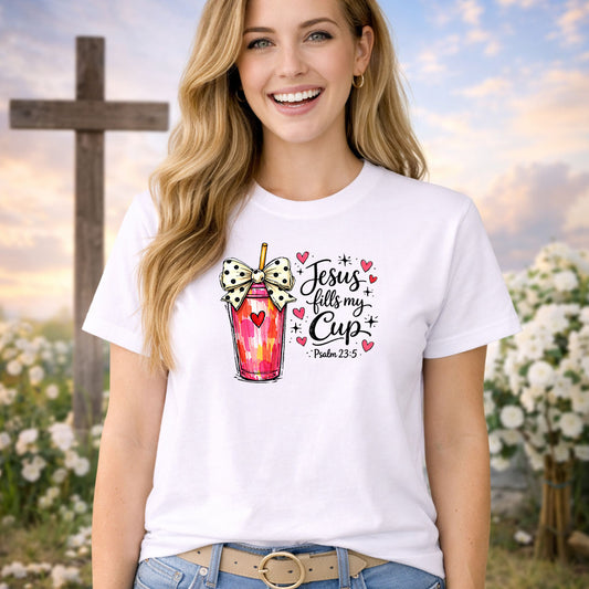 Jesus Fills My Cup DTF transfer design mockup on a t-shirt featuring a watercolor tumbler cup with a bow and heart with Psalm 23:5 Jesus fills my cup script lettering