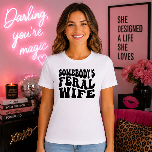 Somebody's Feral Wife DTF transfer design mockup on a t-shirt featuring bold black SOMEBODY'S FERAL WIFE retro typography with Some Things Are Better Left Alone subtitle