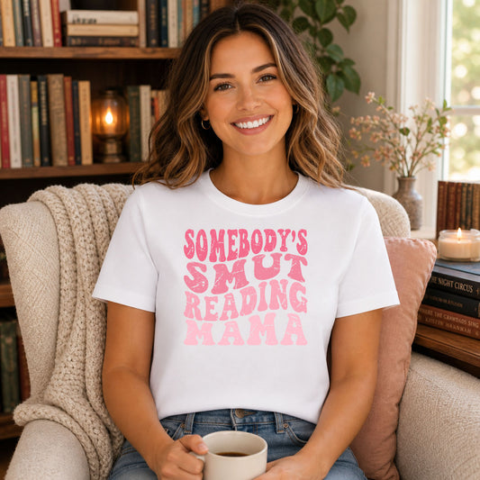 Somebody's Smut Reading Mama DTF transfer mockup on a t-shirt featuring pink retro stacked Somebody's Smut Reading Mama typography