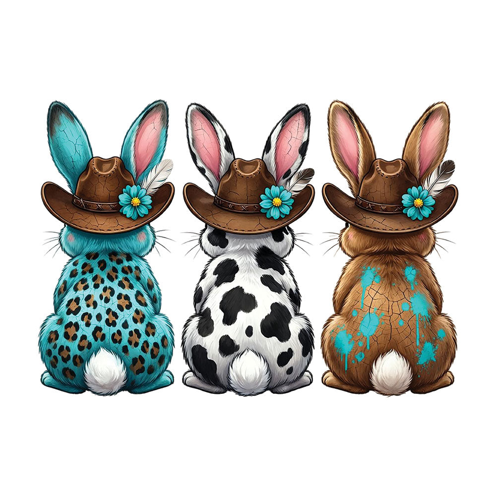 Three Western Bunnies DTF transfer design featuring three bunnies seen from behind wearing brown cowboy hats with patterned bodies in turquoise leopard, black cow print and turquoise floral