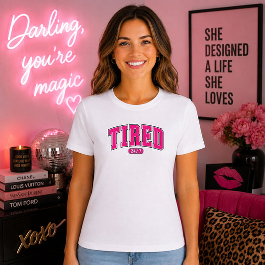 Tired 24/7 Varsity DTF transfer mockup on a t-shirt featuring pink varsity-style TIRED lettering with a 24/7 pill badge