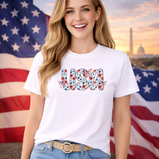 USA Coquette Floral DTF transfer design mockup on a t-shirt featuring USA in red white blue with floral and ribbon bow accents