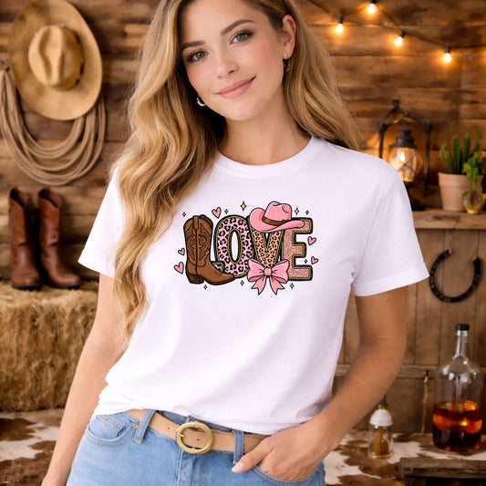 Western Pink Love DTF transfer design mockup on a white t-shirt featuring LOVE in leopard pink with cowboy boot, hat and pink bow accents